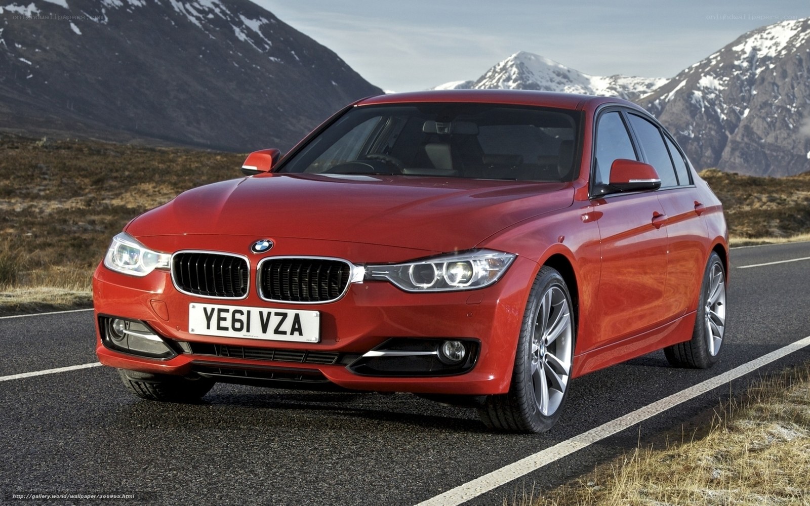 Red BMW 3 Series on mountain road