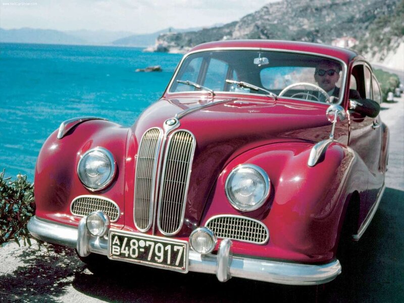 Red BMW 328 on a coastal road