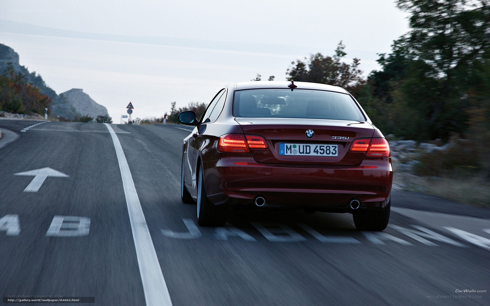 Red BMW 335i on a winding road