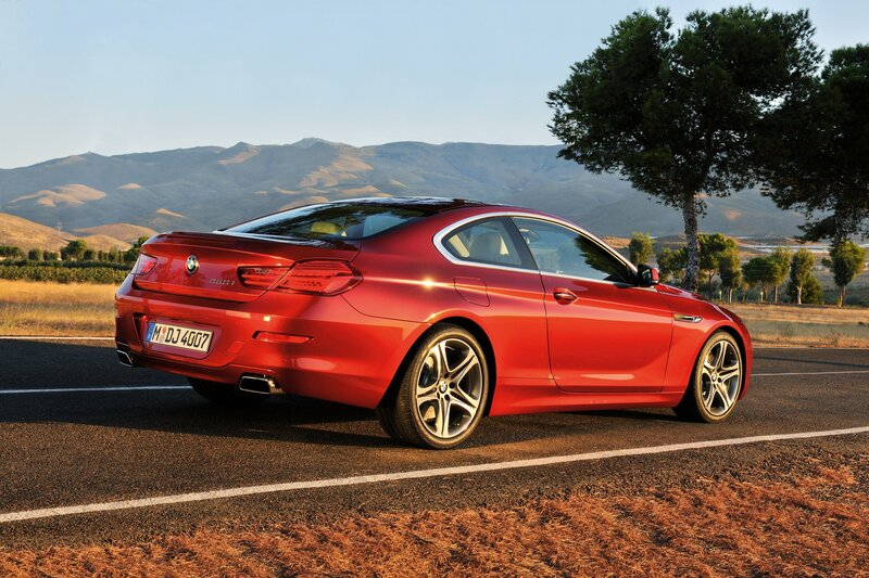 Red BMW 6 Series on a scenic road