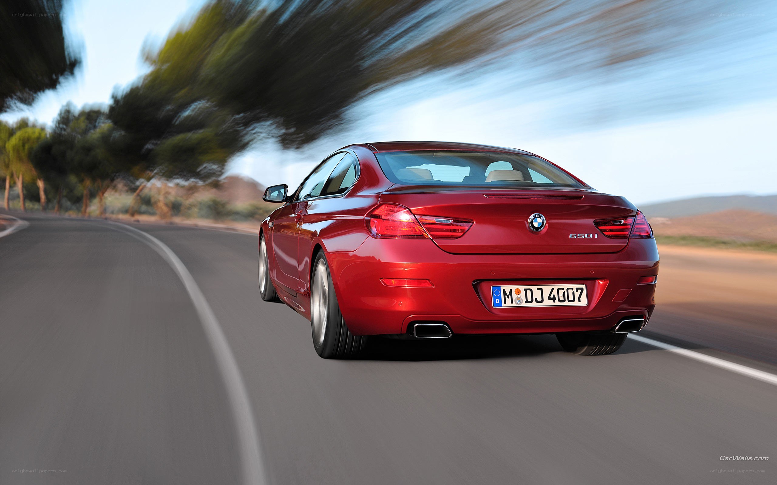 red bmw 650i in motion