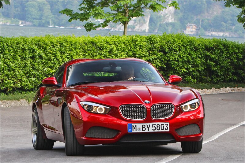 Red BMW concept car on lake road