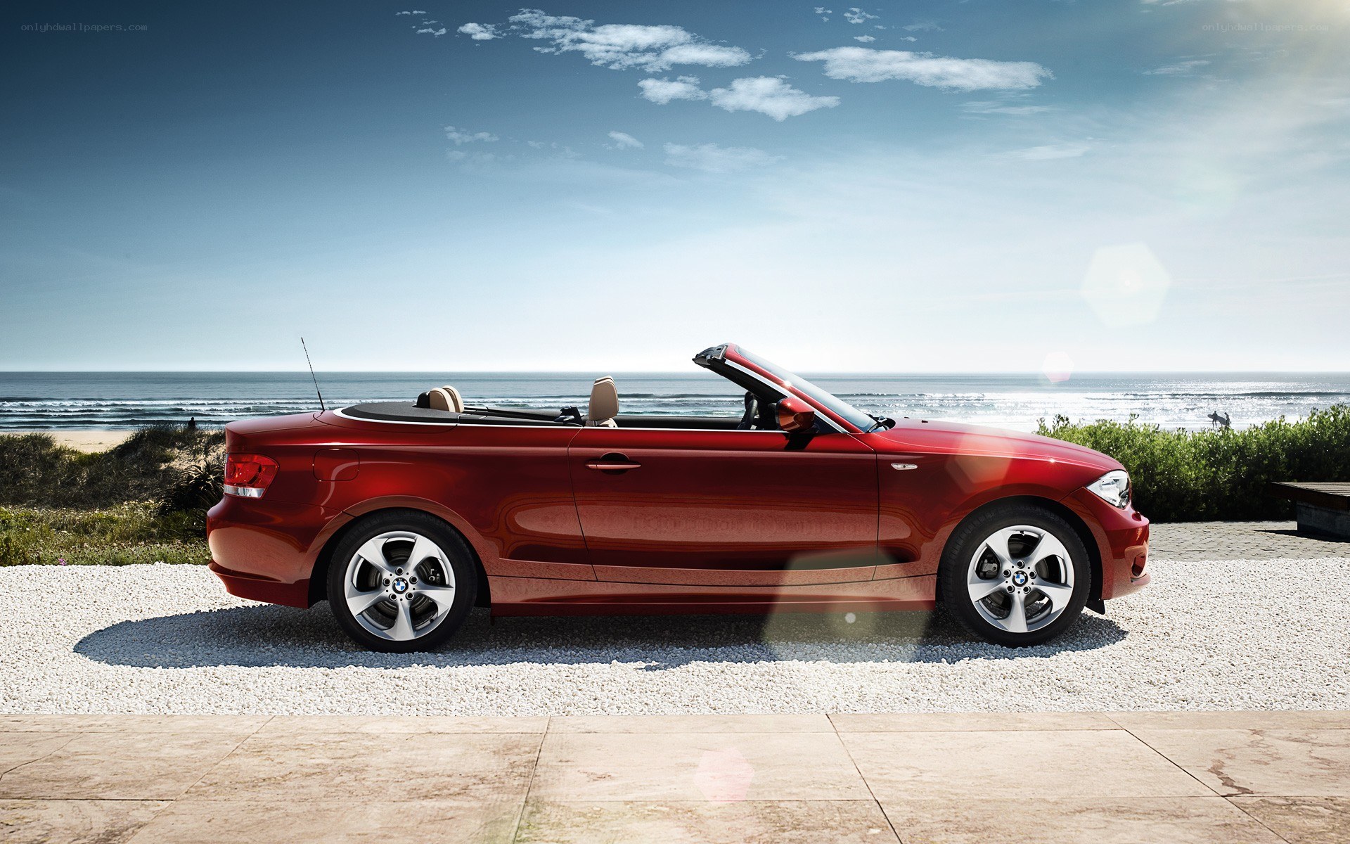 Red BMW convertible by the sea