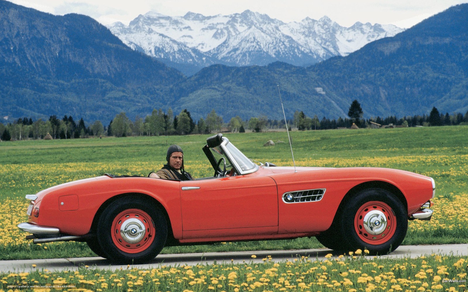 Red BMW convertible in mountains