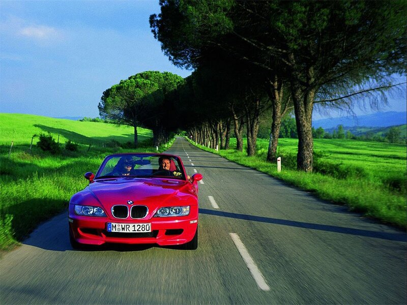Red BMW convertible on a country road