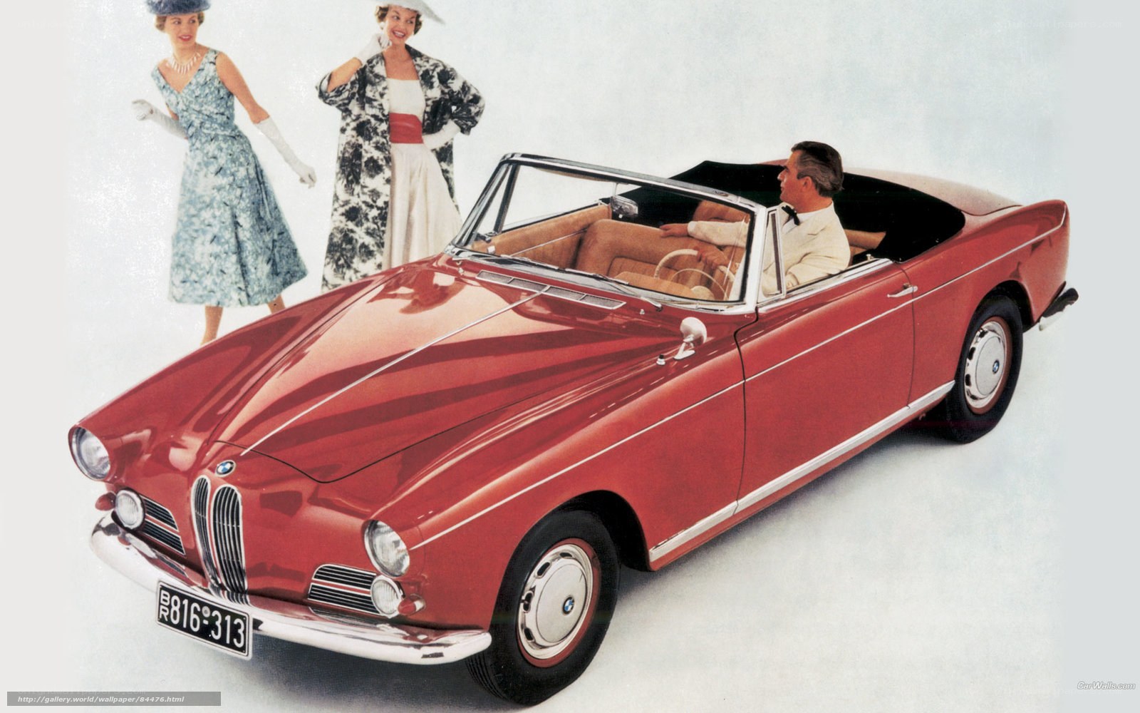 Red BMW convertible with passengers