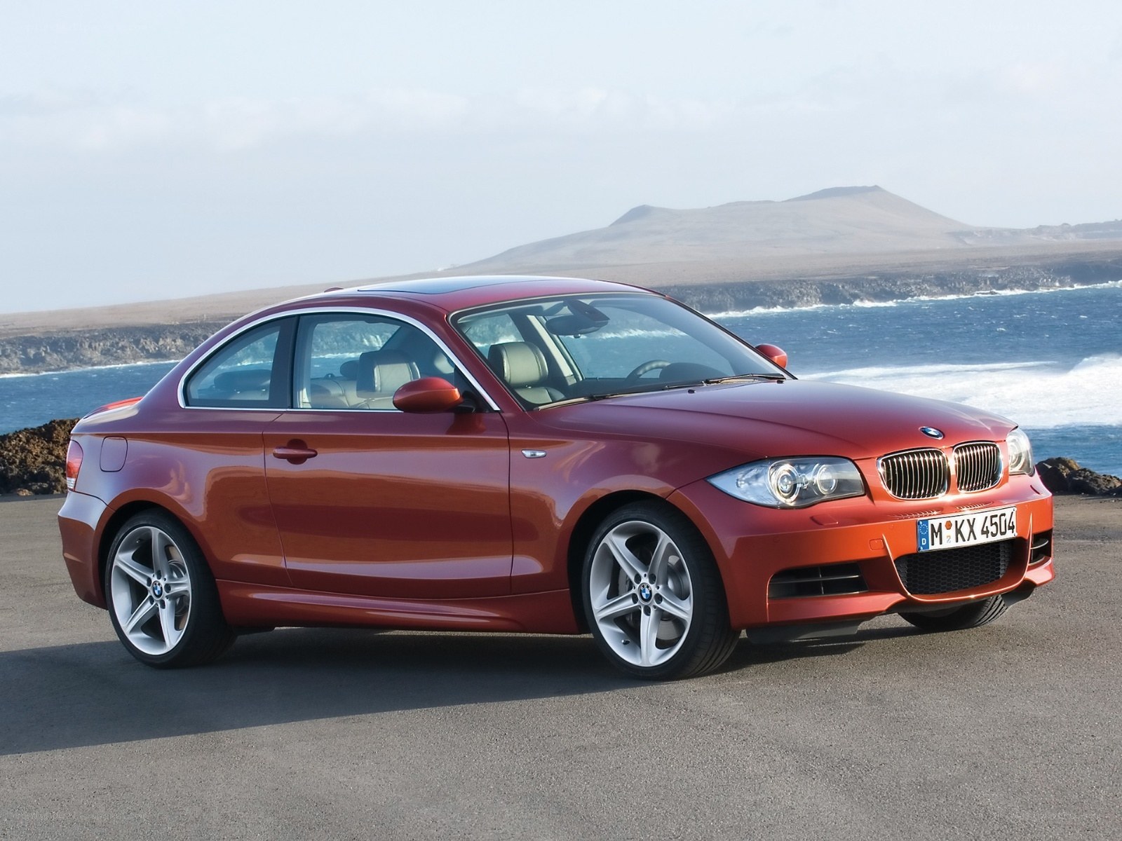 Red BMW coupe by the sea