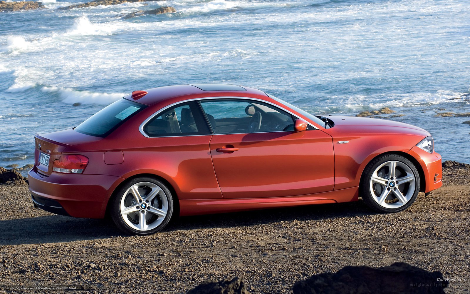 Red BMW coupe by the sea