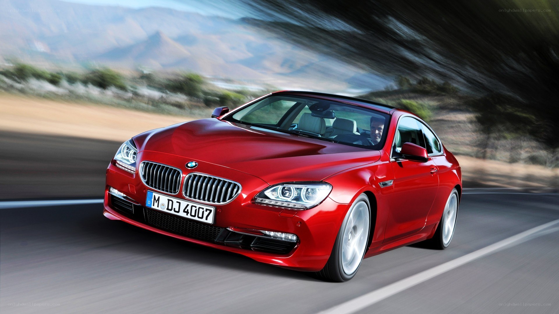 Red BMW coupe in motion