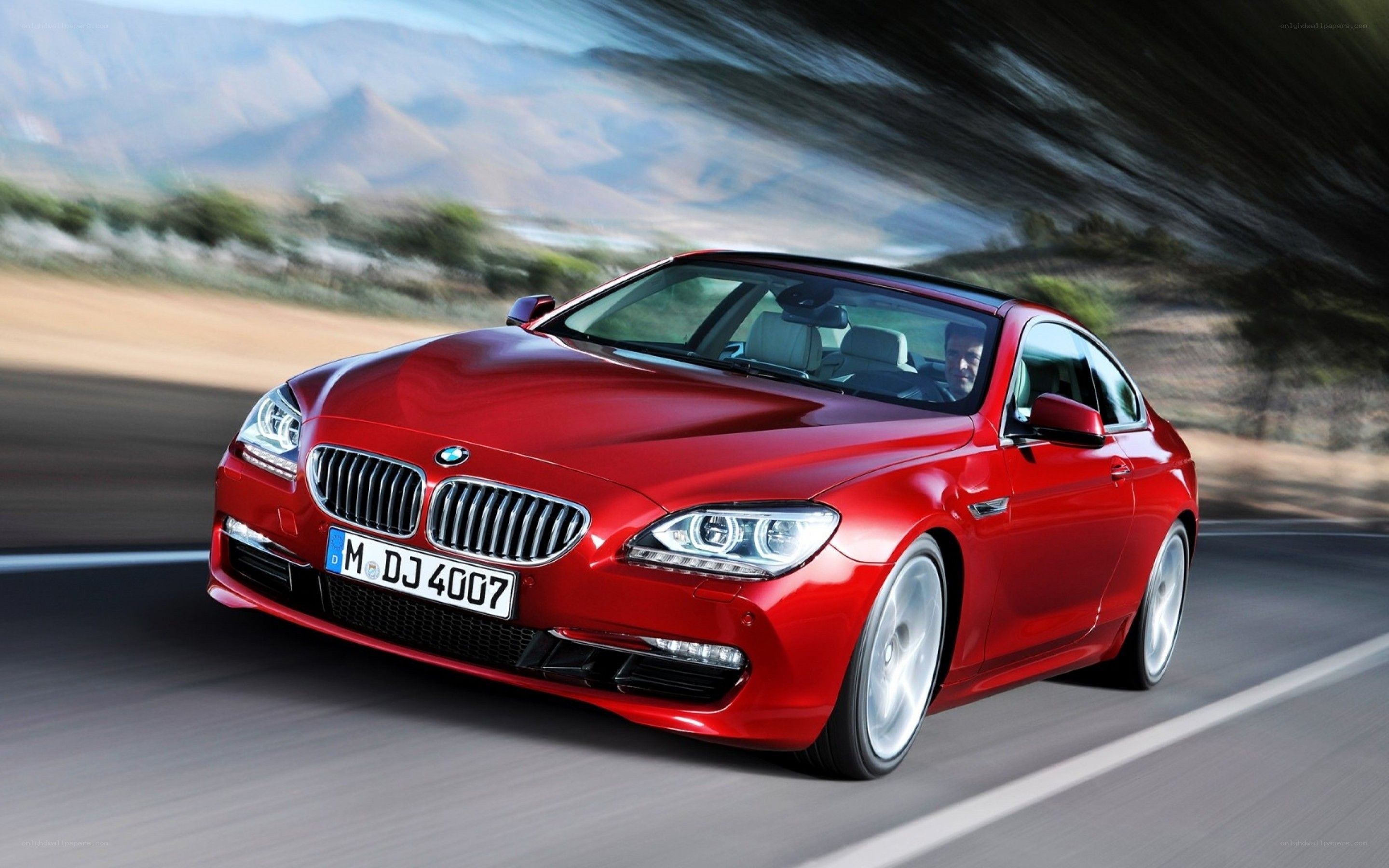 Red BMW coupe in motion