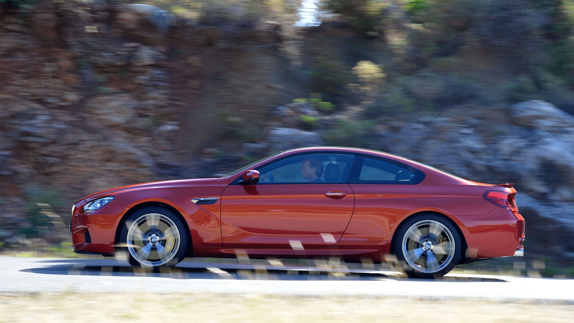 red bmw coupe in motion