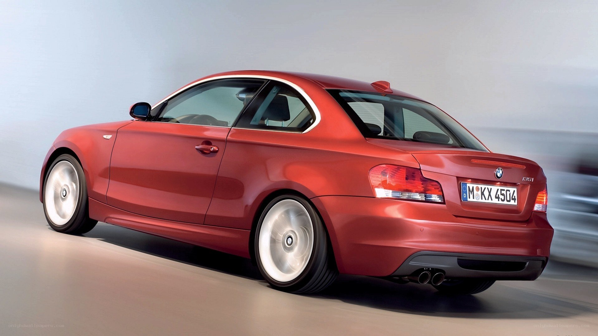 red bmw coupe in motion
