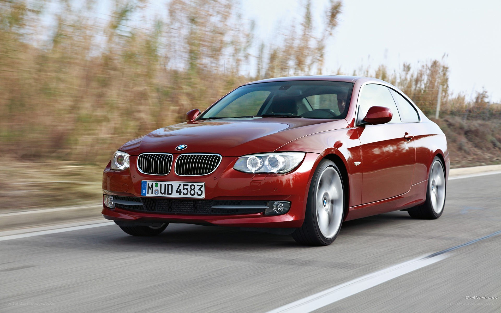 red bmw coupe in motion