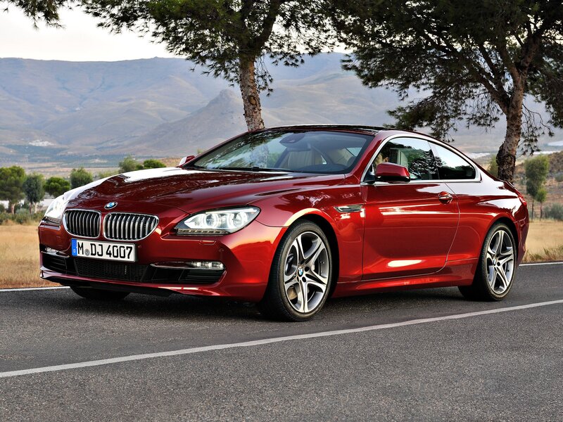 Red BMW coupe on a road