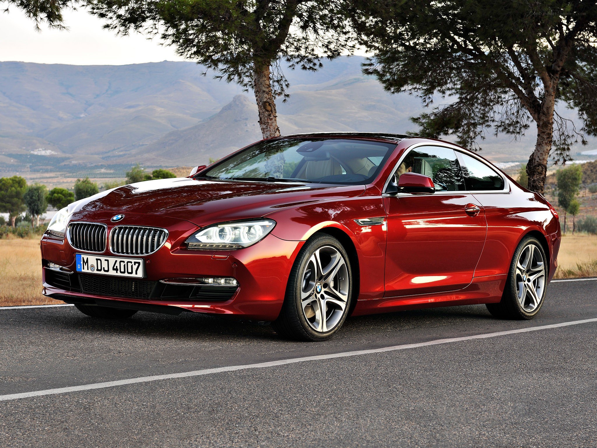 Red BMW coupe on a road