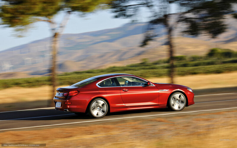 Red BMW coupe on a road