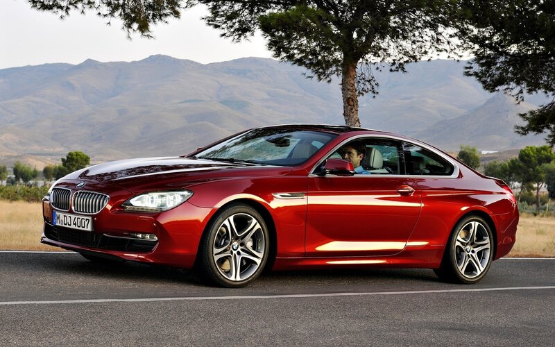 Red BMW coupe on a scenic road