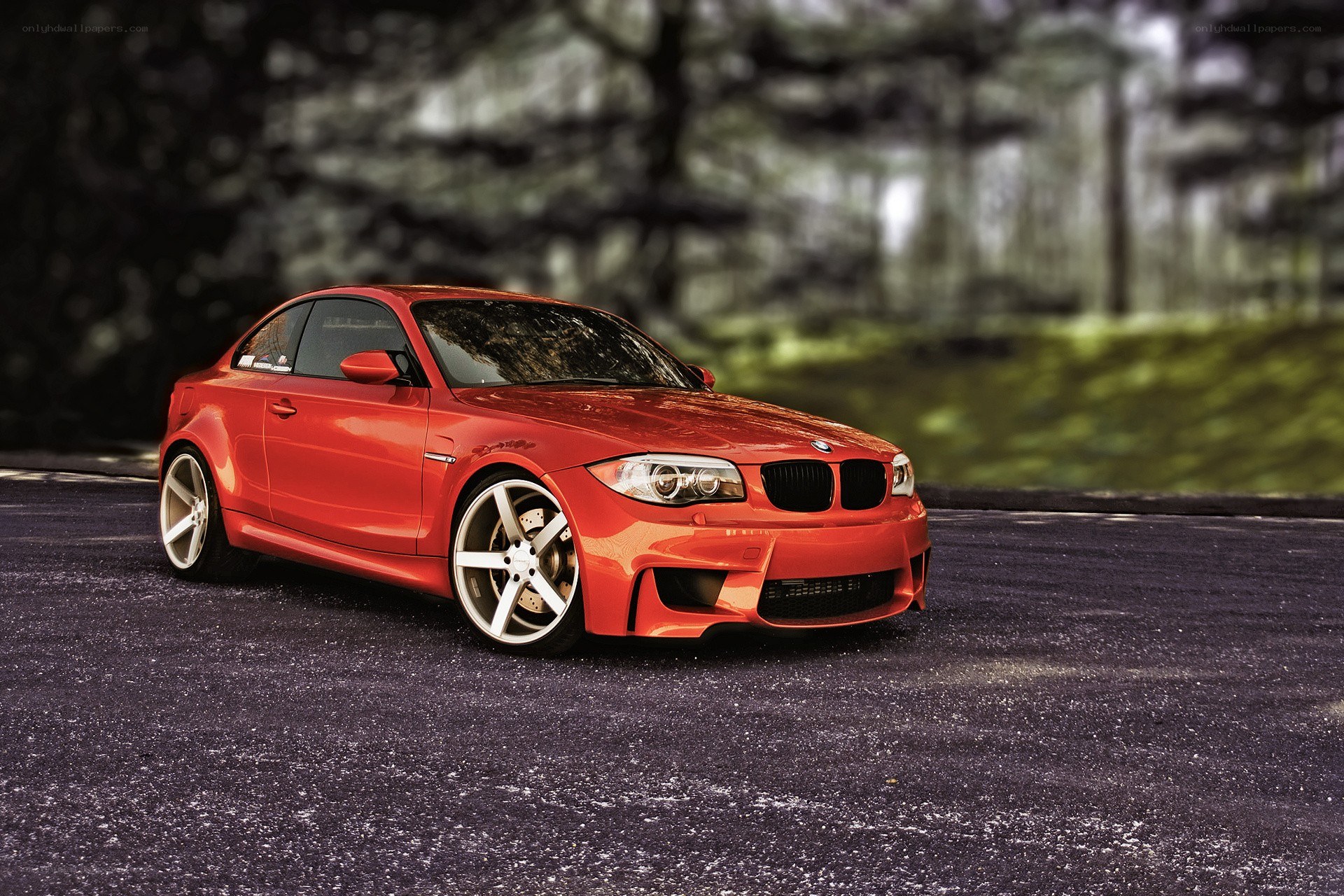 Red BMW coupe on asphalt