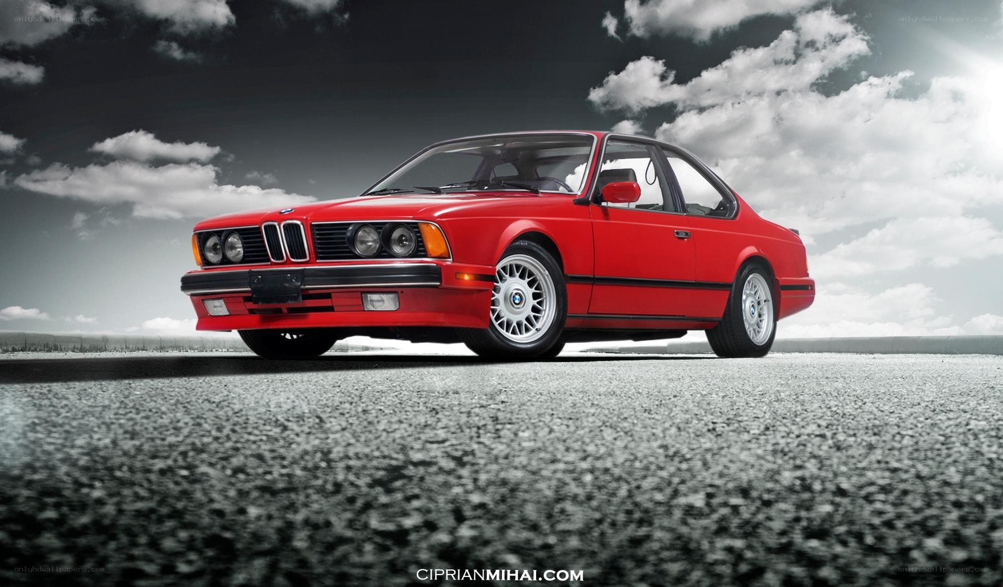 Red BMW coupe on asphalt