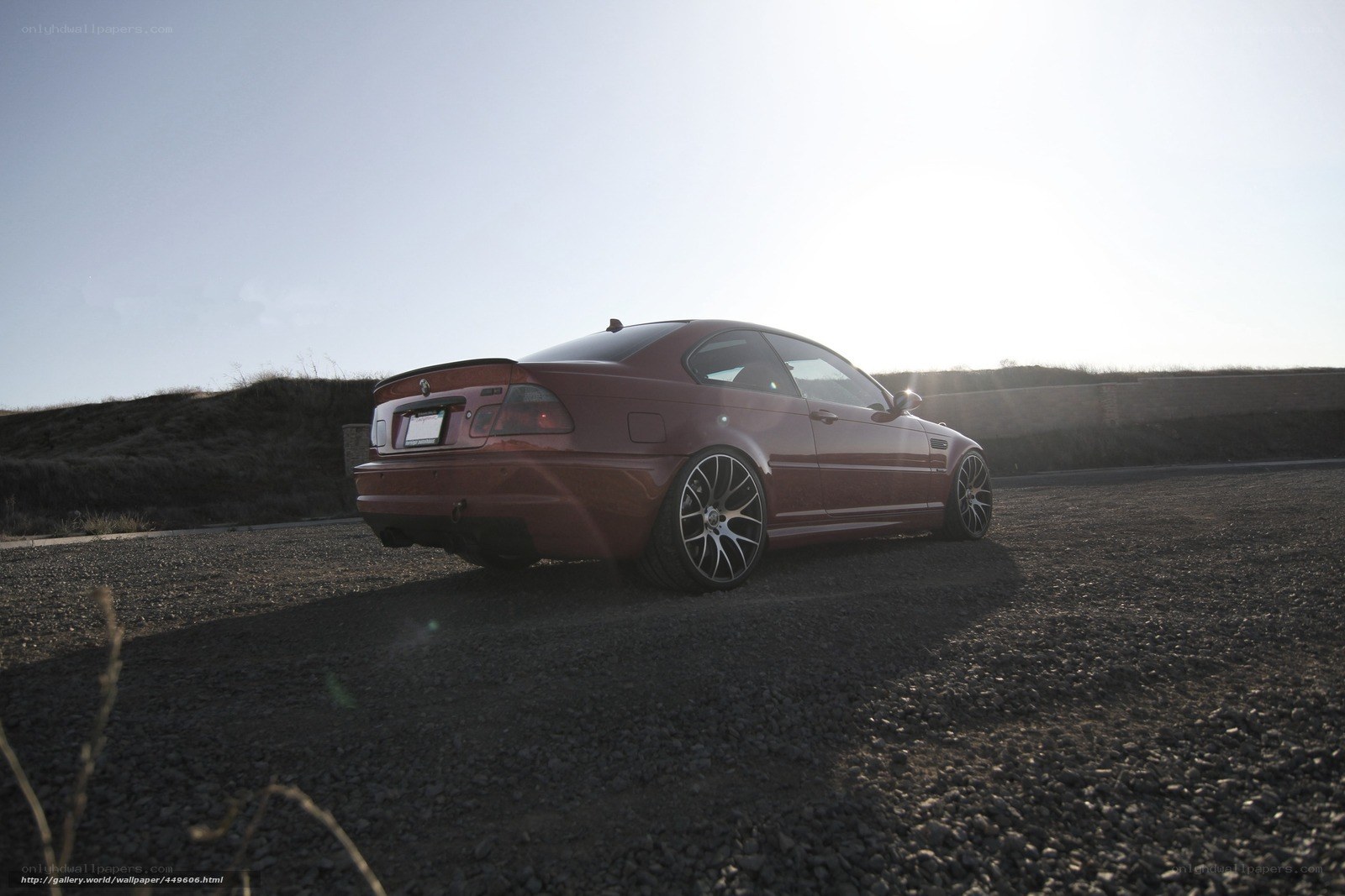 red bmw coupe on gravel