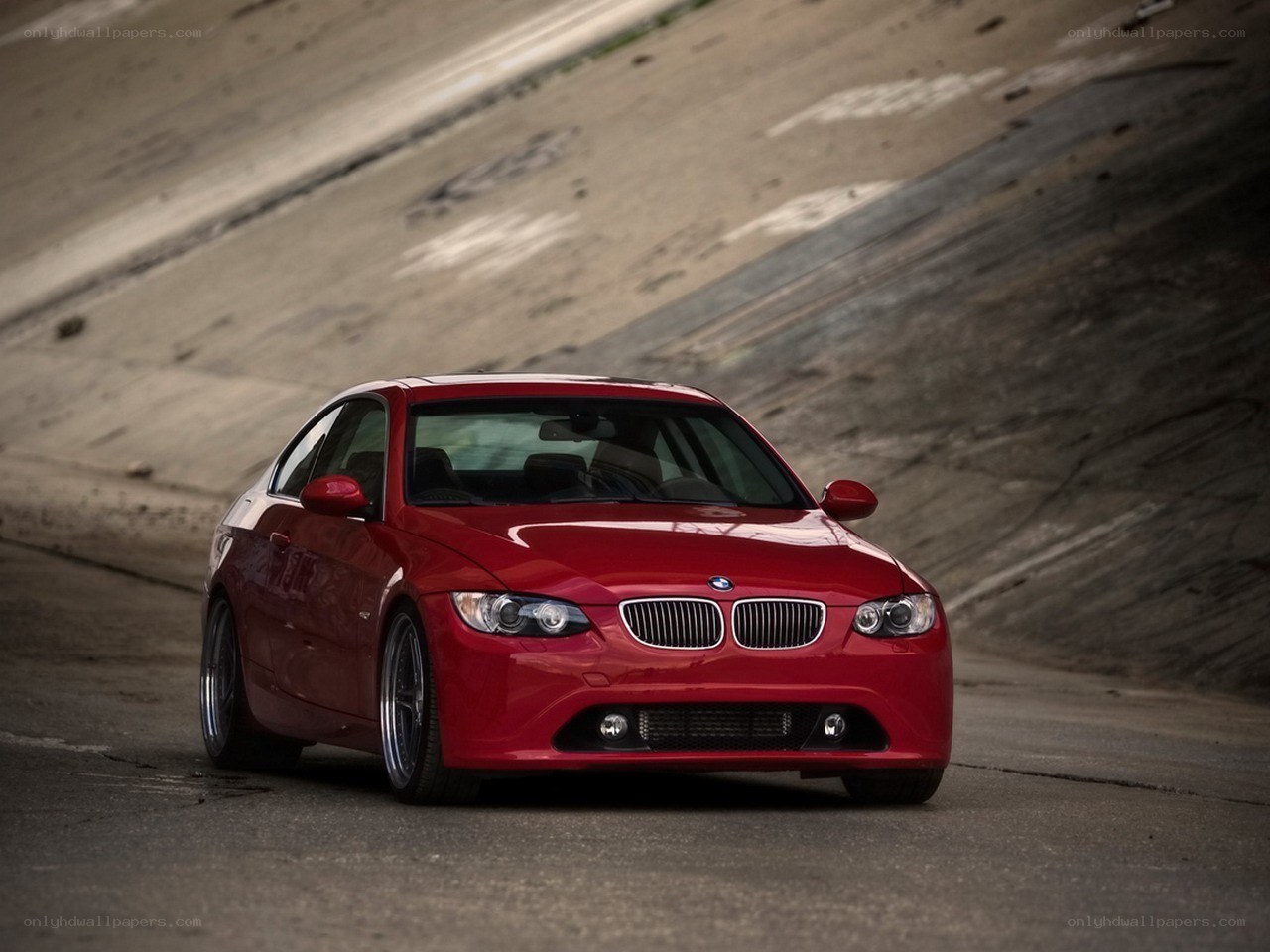 Red BMW coupe on road