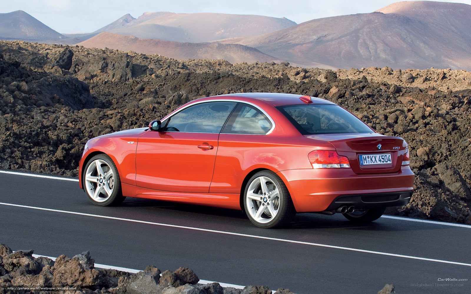 Red BMW coupe on volcanic road
