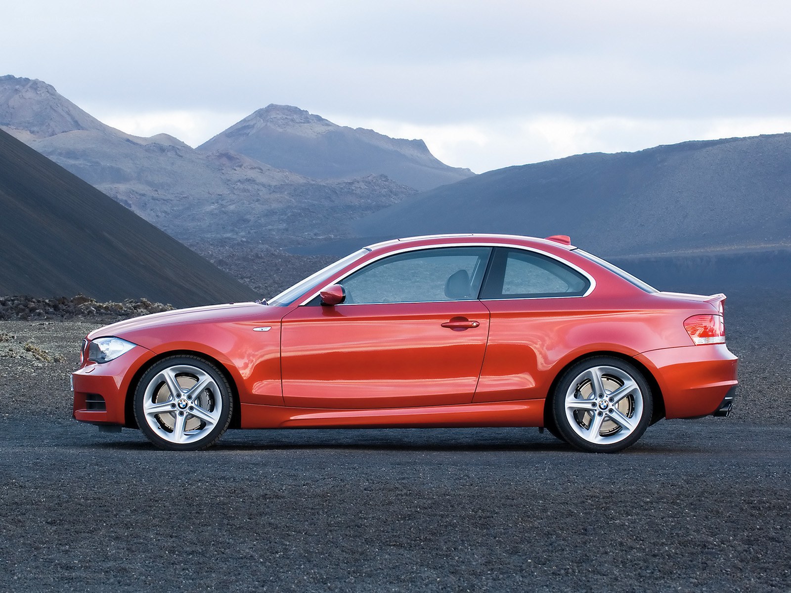 Red BMW coupe on volcanic terrain