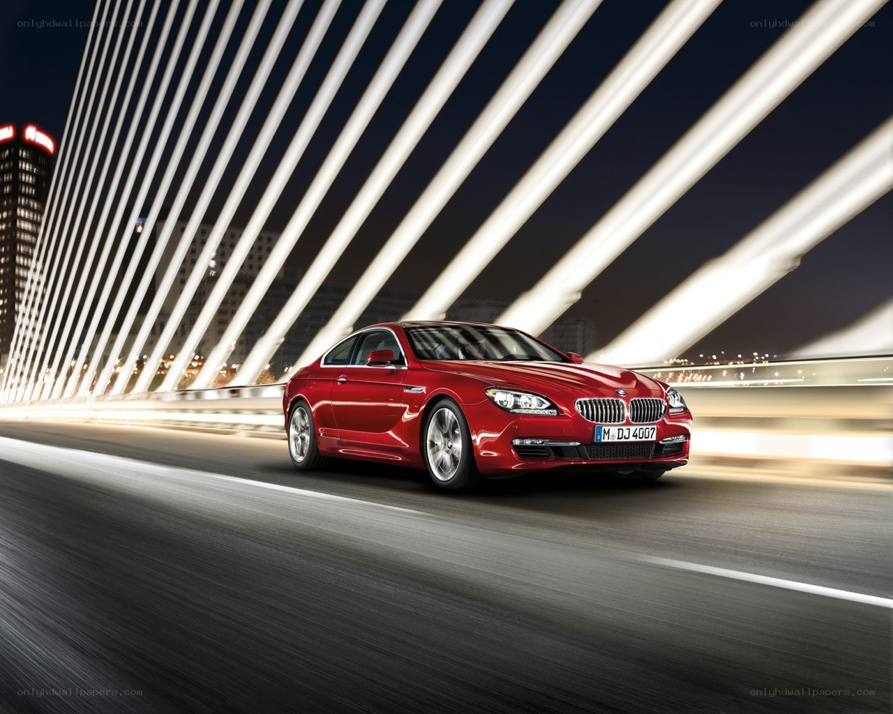 Red BMW driving at night