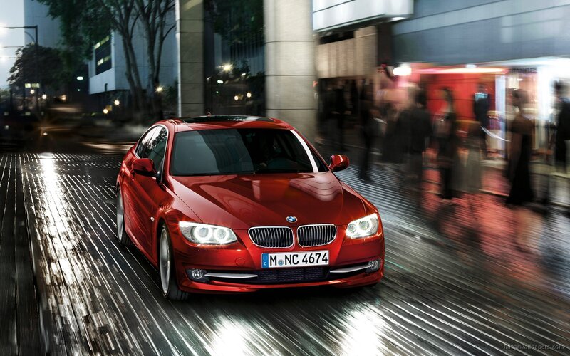 Red BMW driving at night