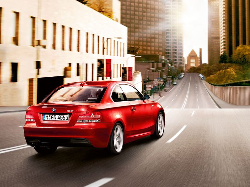 Red BMW driving in city