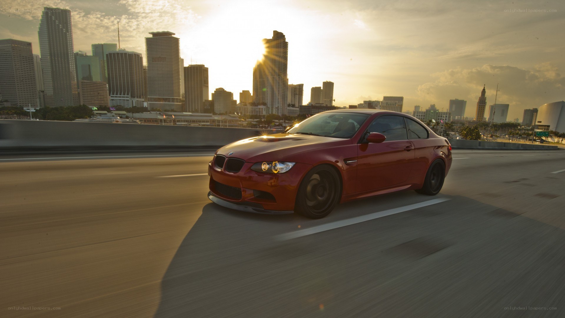 red bmw driving in city