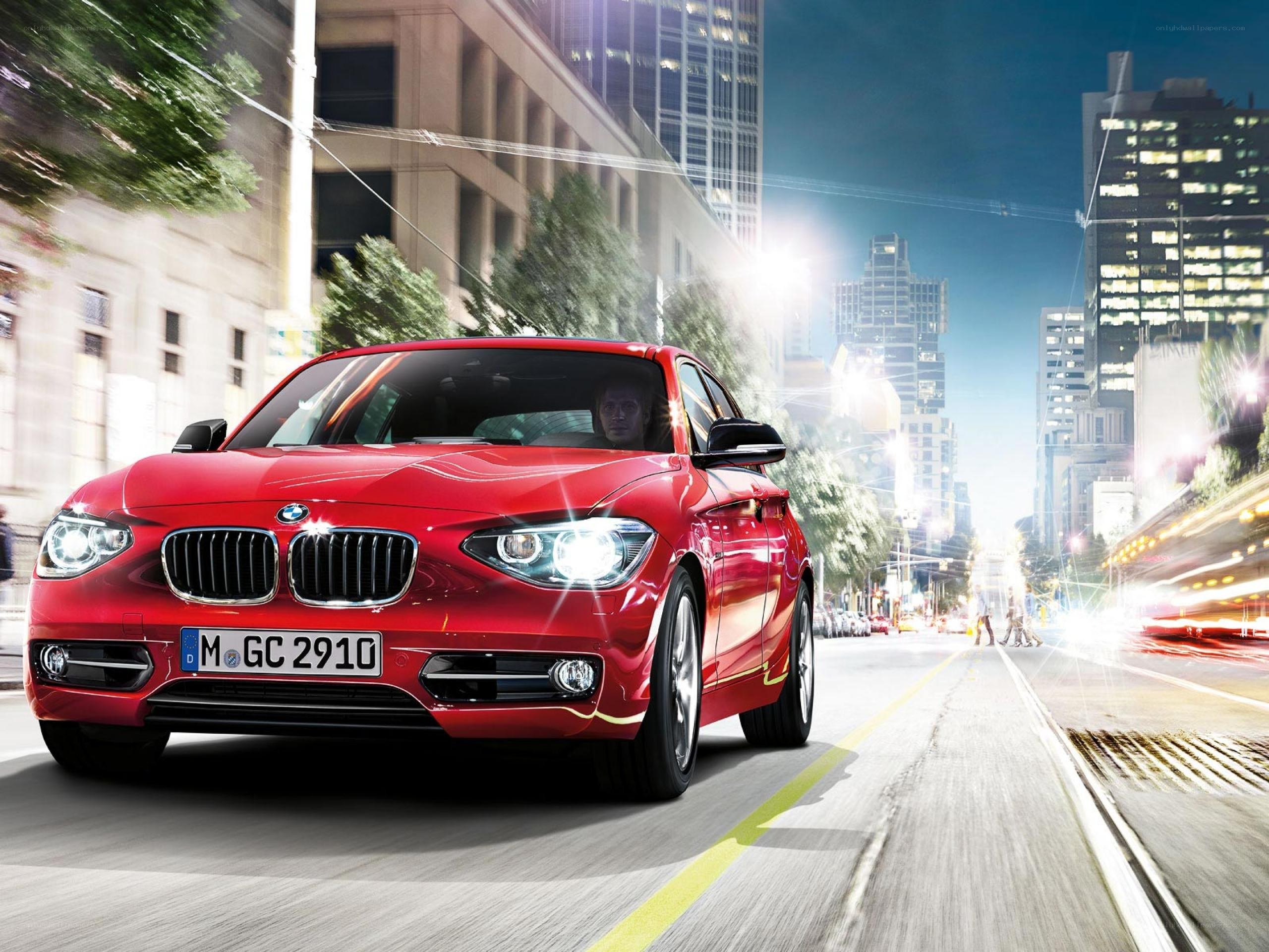 Red BMW driving in city