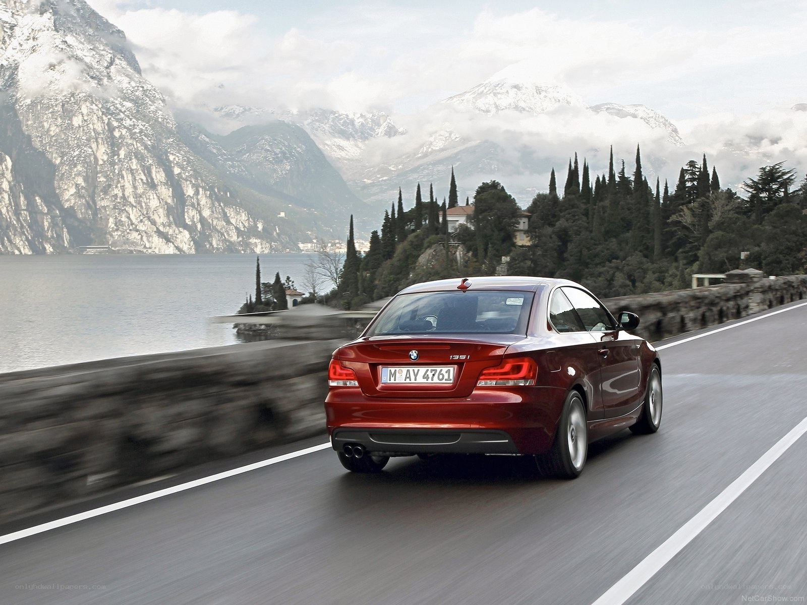 Red BMW driving on lakeside road