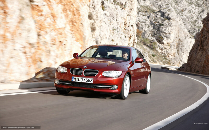 Red BMW driving on mountain road