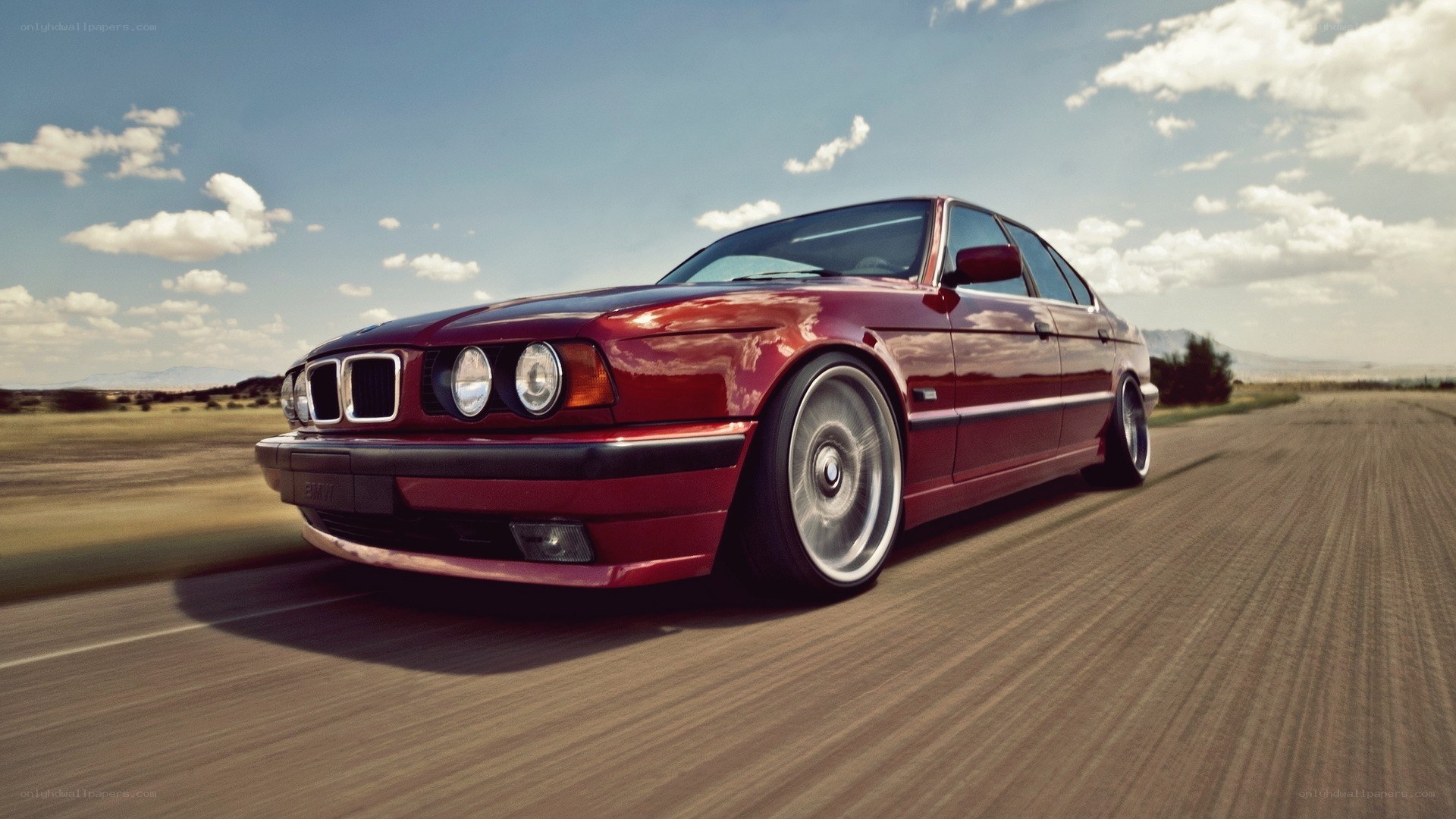 red bmw driving on road