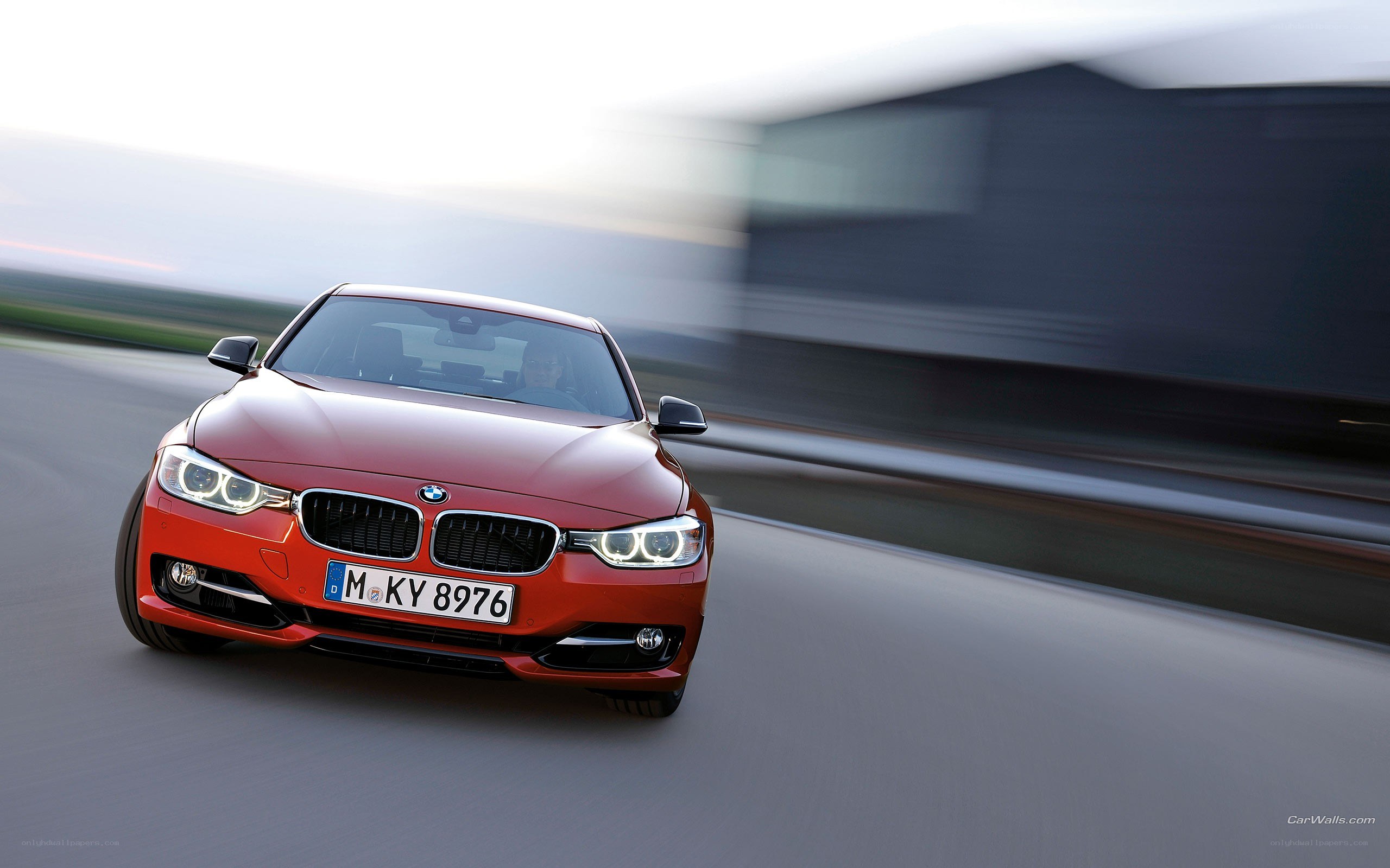 red bmw driving on road