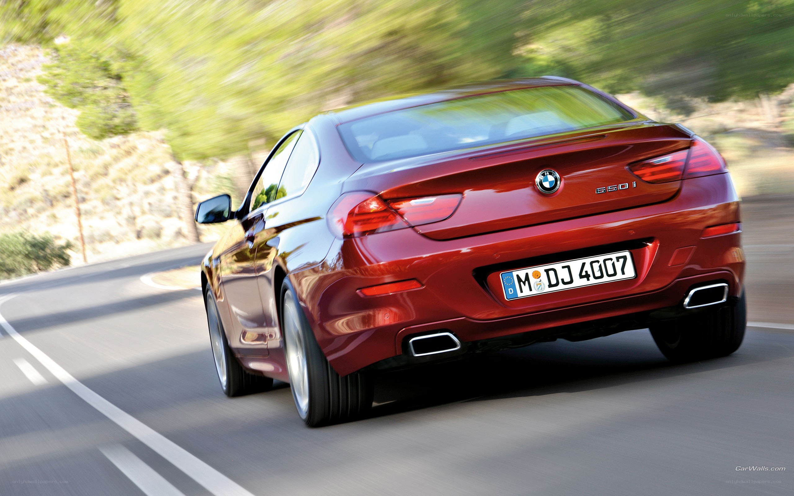 red bmw driving on road