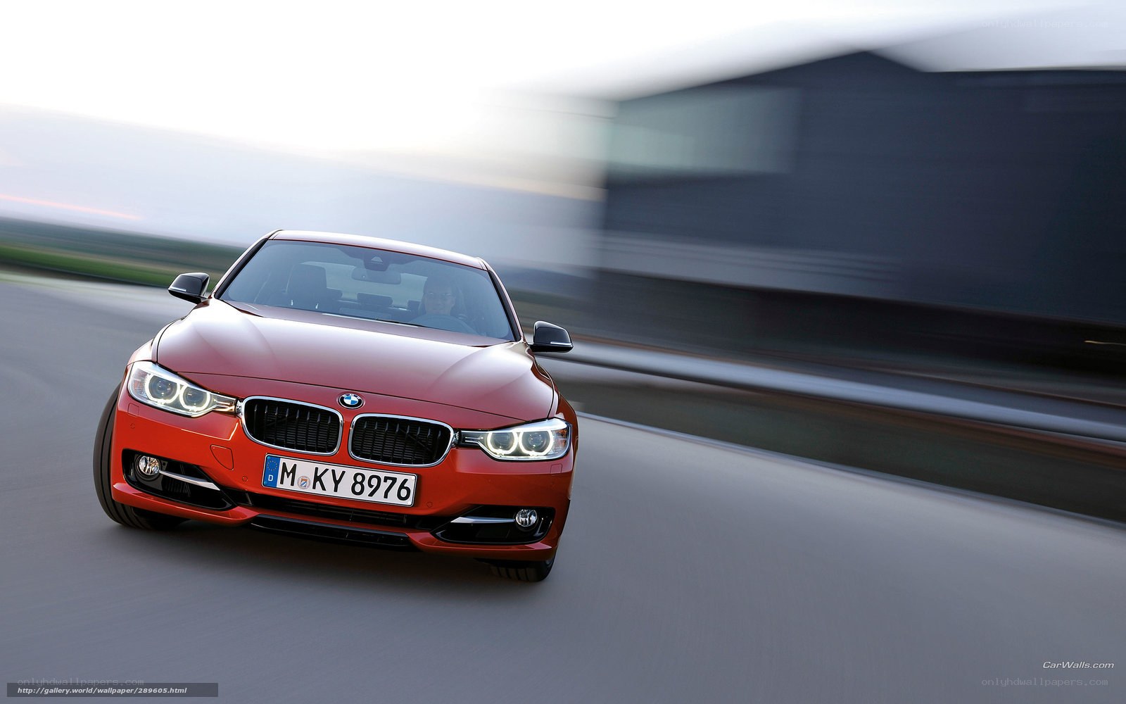 red bmw driving on road