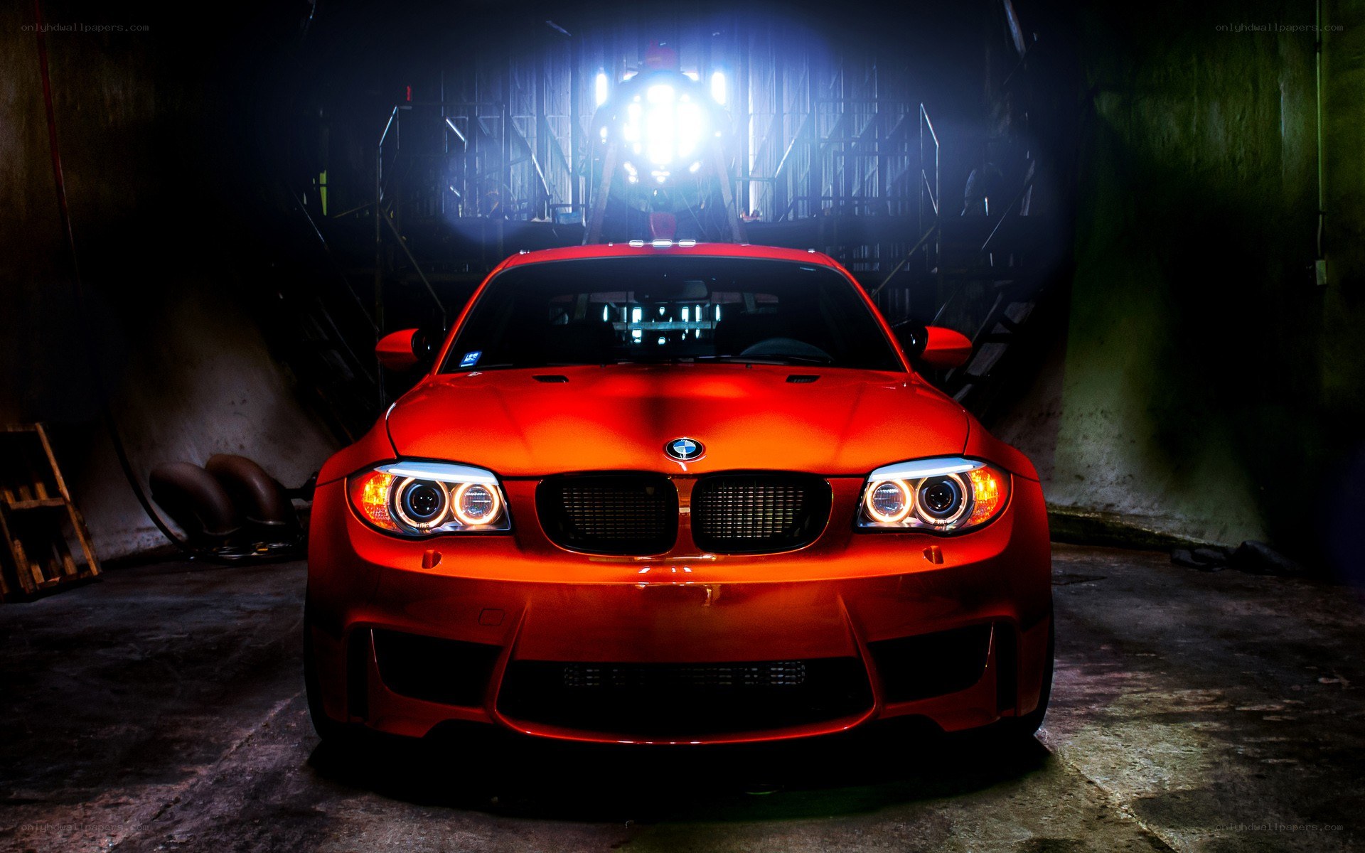 Red BMW in a dark garage