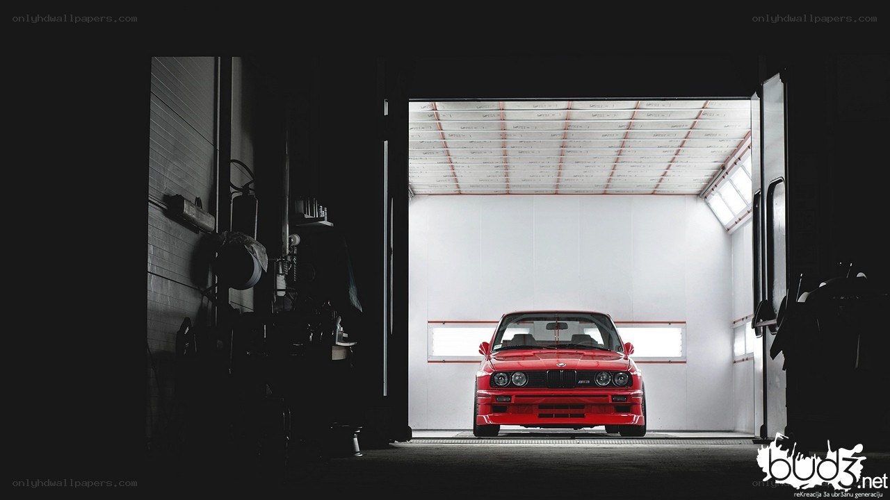 Red BMW in a garage