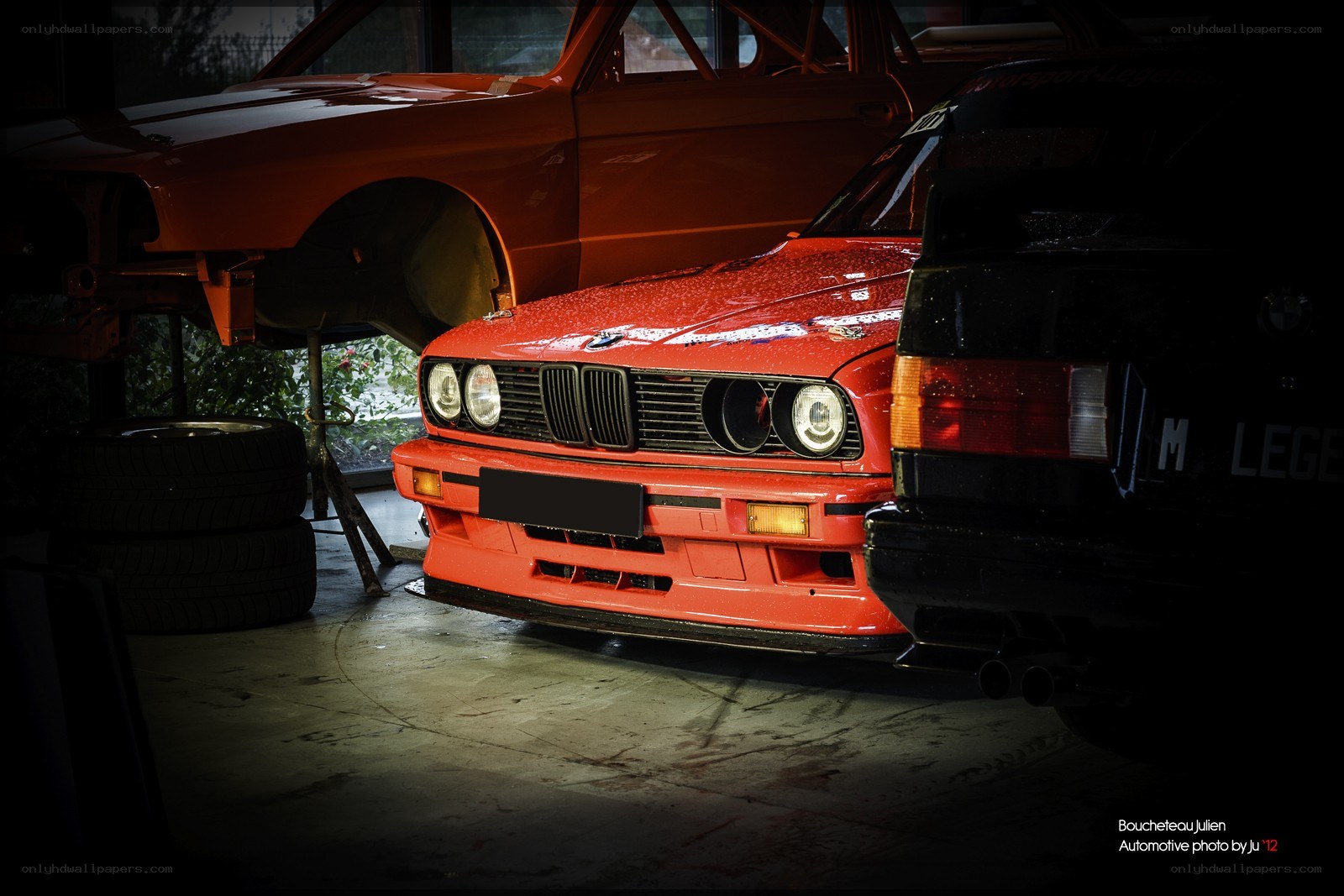 Red BMW in a garage