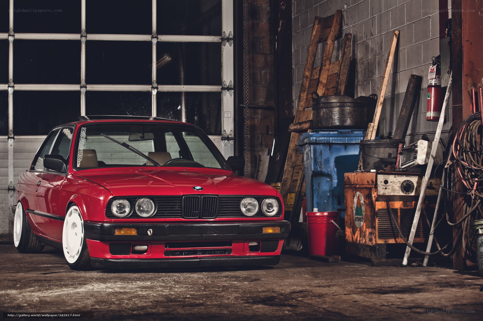 Red BMW in a garage