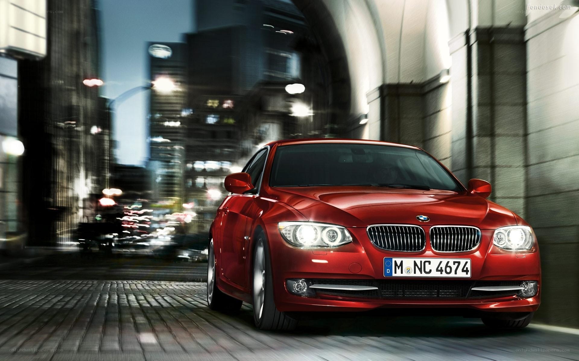 Red BMW in city at night