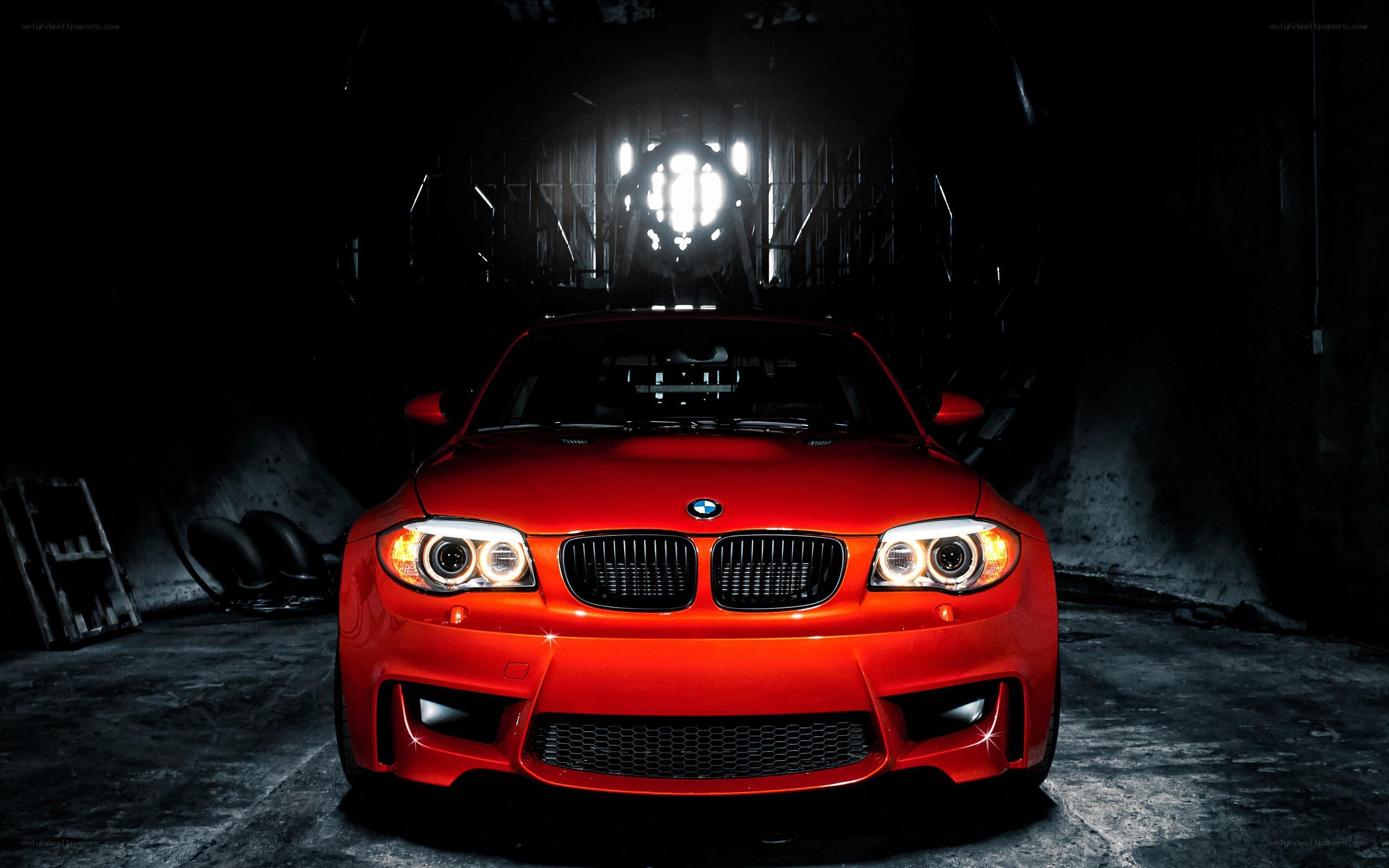 Red BMW in dark garage