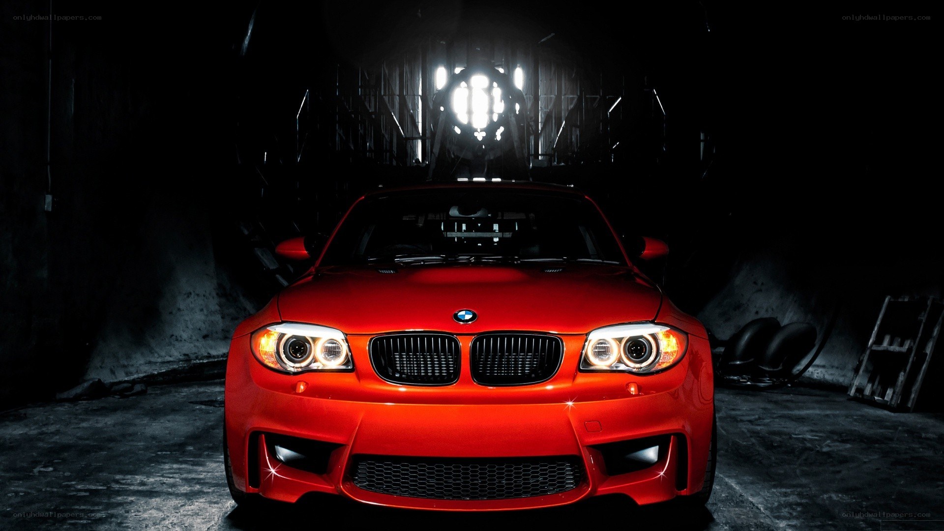 Red BMW in dark garage