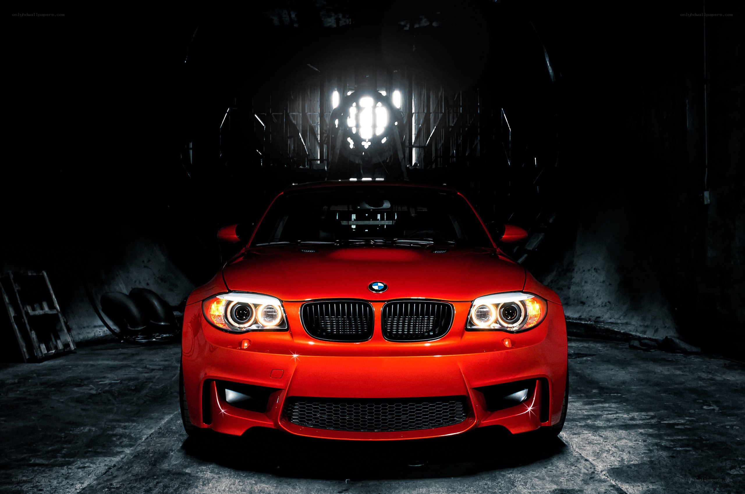 Red BMW in dark garage