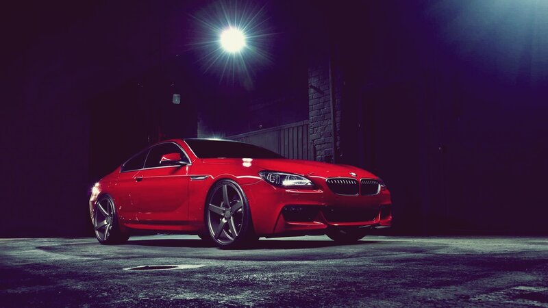 Red BMW in dark garage