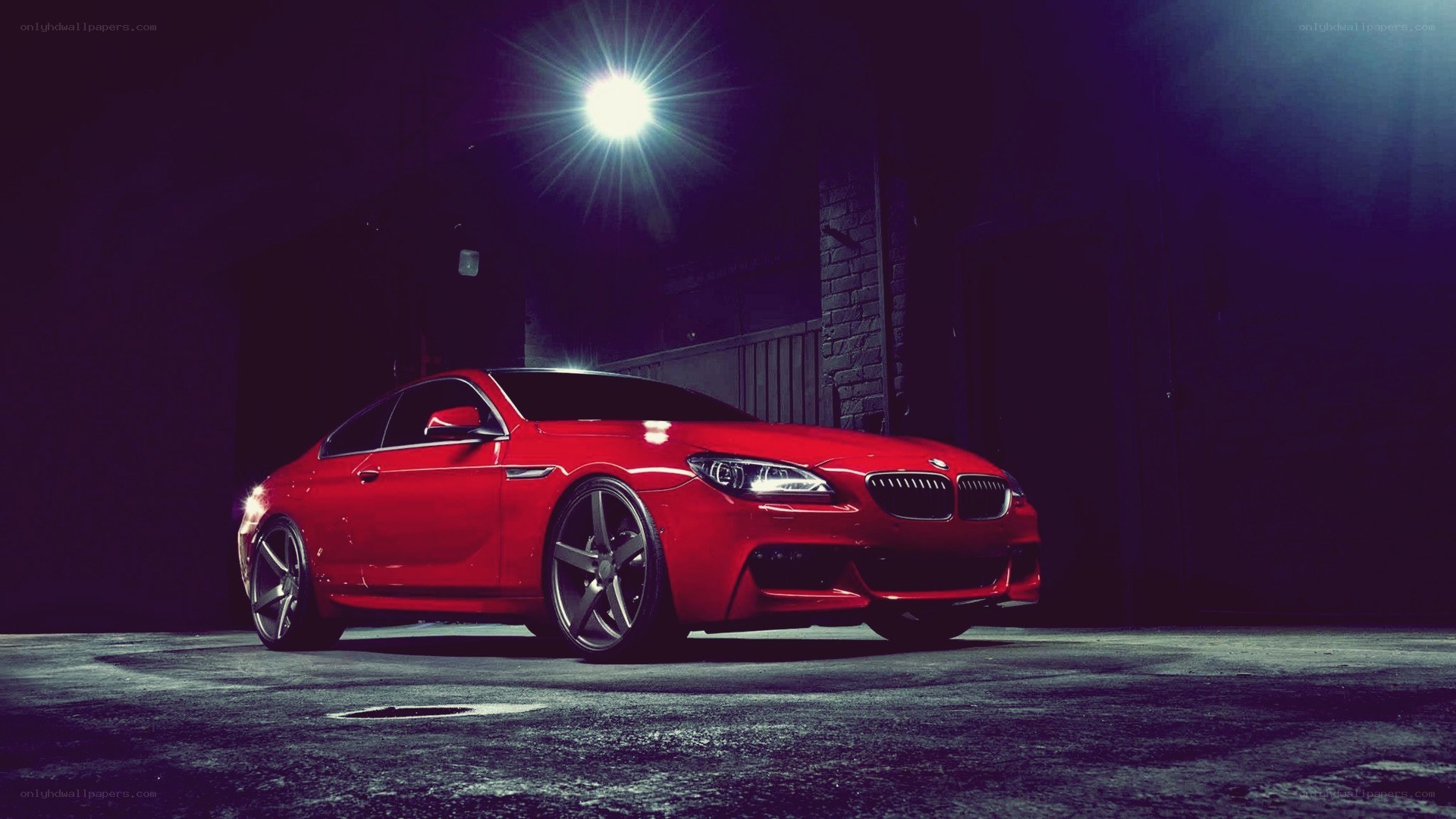 Red BMW in dark garage