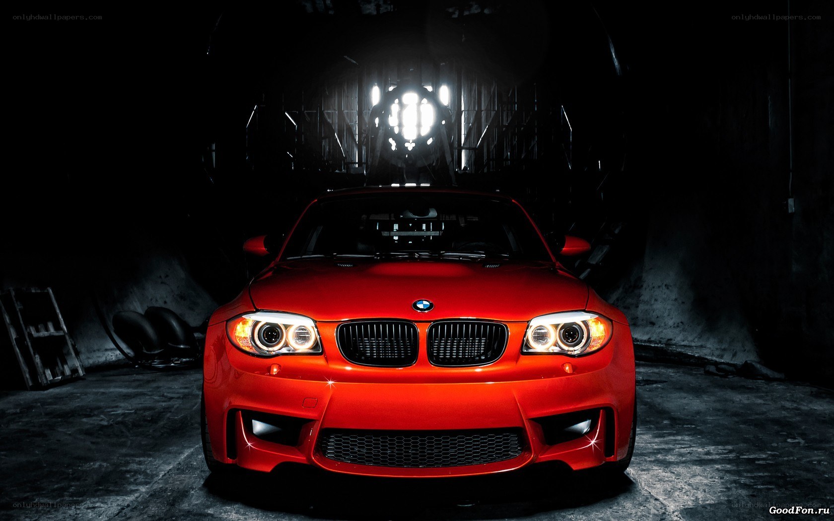 Red BMW in dark garage