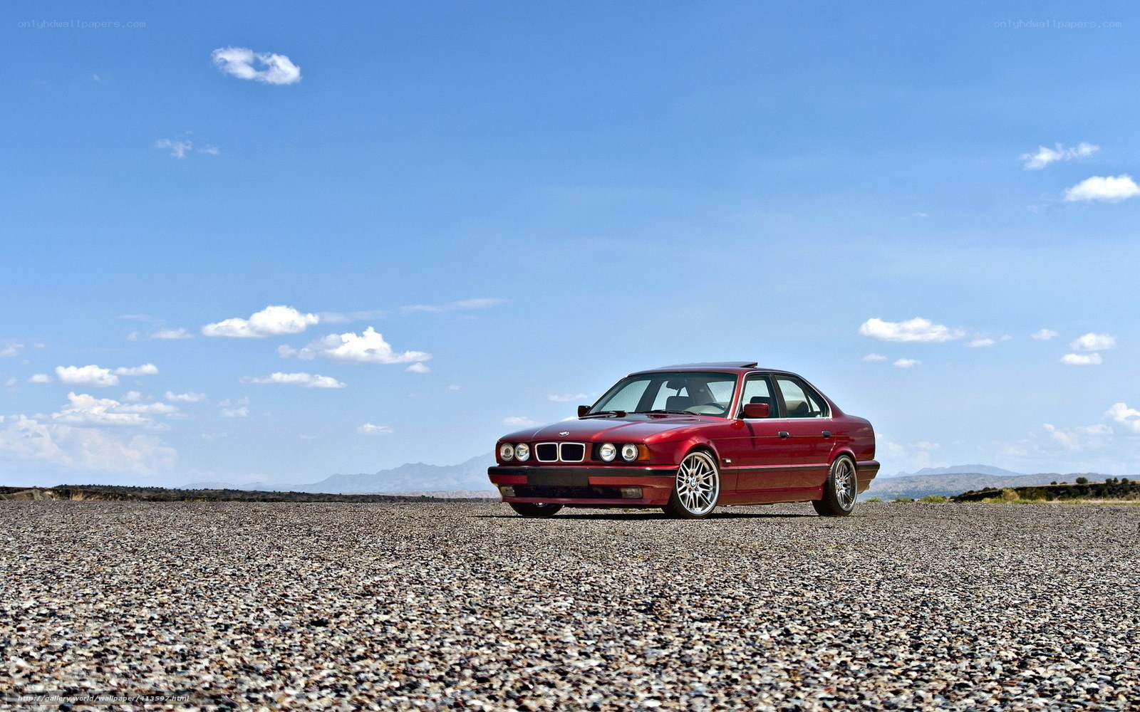 Red BMW in desert landscape